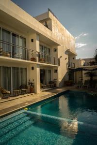 a house with a swimming pool in front of a building at Eloína Hotel Boutique in Chiapa de Corzo