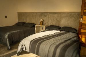 a bedroom with two beds and a table with a lamp at Eloína Hotel Boutique in Chiapa de Corzo +16 photos