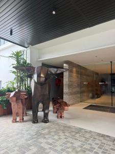 a statue of three cows in a lobby at Roxy Hotel & Apartment Lawas in Lawas