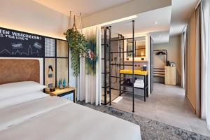a hotel room with a bed and a bathroom at Me and All Hotel Ulm, by Hyatt in Ulm +45 photos