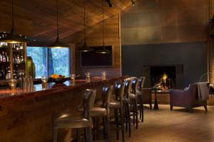 a bar with a row of stools in a room at Alila Ventana Big Sur in Big Sur