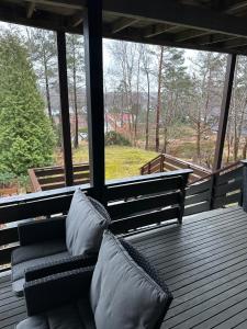 a bench on a porch with pillows on it at Stavern Terrace in Larvik