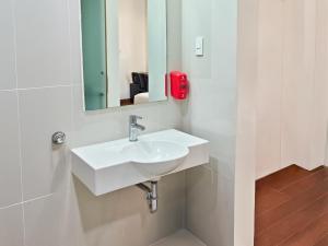a bathroom with a white sink and a mirror at Red Planet Cebu in Cebu City