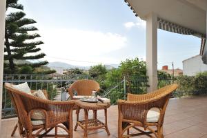 um pátio com uma mesa e cadeiras num alpendre em The Dream House in Sardinia em Bari Sardo