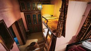 an overhead view of a room with a bed and a door at La Kasbah Salam Hostel in Fez