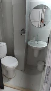 a white bathroom with a toilet and a sink at ZÜMRÜT KONAĞı in Mardin +82 photos