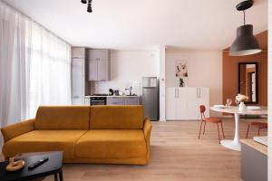 a living room with a couch and a kitchen at Sika Platinum Apartment - cazare premium Arad - self check-in in Arad