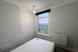 a white room with a bed and a window at Stylish double room in Mansfield