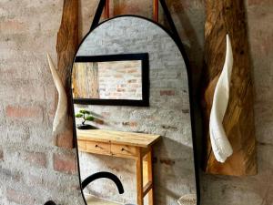 a mirror on a wall with a wooden table at Syeta Bush Lodge - Luxury Bush Villa in Crocodile Valley Estates