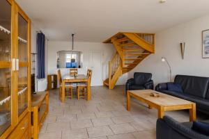 a living room with a couch and a table at Haus im Halligweg 20 in Nordstrand