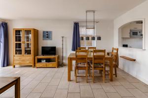 a kitchen and dining room with a table and chairs at Haus im Halligweg 20 in Nordstrand