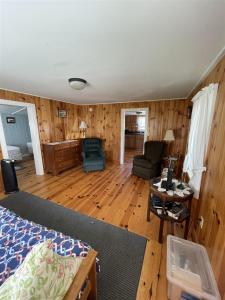 a living room with a bed and a table at THE SHOPPE LIMIT 3 cabin in North Sebago