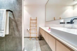 a bathroom with a sink and a mirror at Domaine d'Anbalaba in Ruisseau Créole
