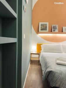 a bedroom with a bed and a green wall at Hotel Nizza Creative Hotel in Rimini