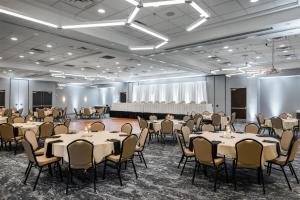 a banquet hall with tables and chairs in a room at Hilton Garden Inn Sioux Falls South in Sioux Falls