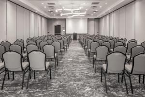 an empty conference room with chairs and a podium at Hilton Garden Inn Sioux Falls South in Sioux Falls