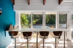a dining room with a white table and chairs at Captain Sandy on the Loop Blairgowrie in Blairgowrie