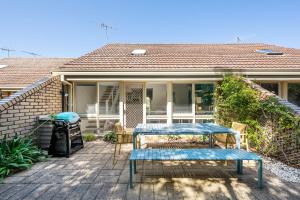a house with a blue table on a patio at Captain Sandy on the Loop Blairgowrie in Blairgowrie