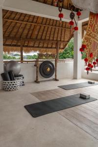 a room with three yoga mats on the floor at The Balangan Hotel Uluwatu - 2min to Beach & 5min to Bali's Best Golf in Uluwatu