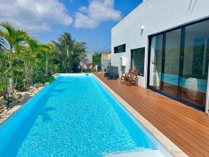 a swimming pool in the backyard of a house at soraniwa hotel and cafe in Miyako-jima