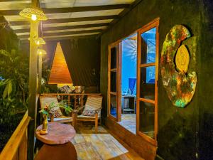 a porch with a table and chairs and a window at Nature Rest Ashored in Sigiriya