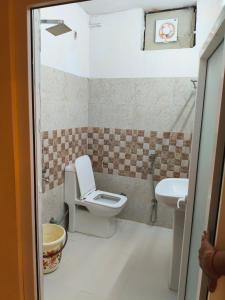 a bathroom with a toilet and a sink at Sai Devine Abode Of SAI at Sri Sathya Sai ghaat in Rishīkesh