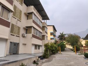 an empty street in front of a building at Sai Devine Abode Of SAI at Sri Sathya Sai ghaat in Rishīkesh