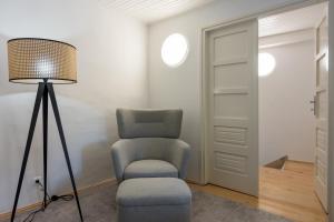 a living room with a chair and a lamp at Veli Lošinj Old Town Apartments in Veli Lošinj +33 photos