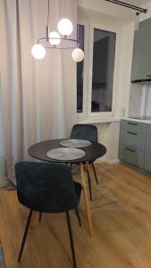 a dining room with a table and two chairs at Peetri Plats Border Apartmens in Narva