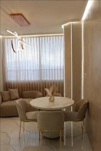 a living room with a table and chairs and a couch at ירושלים a in Safed