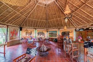 a room with a large room with tables and chairs at Buffalo's Rest Greenpark-Naivasha in Naivasha