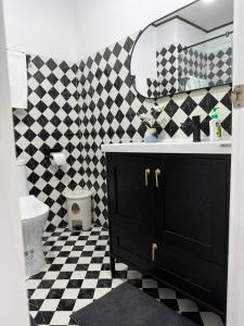 a bathroom with a black and white checkered floor at Le Noci Room 2203 in Ao Nang Beach +2 photos