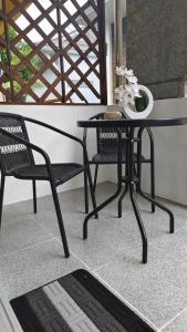 a black table and two chairs on a balcony at Le Noci Room 2203 in Ao Nang Beach