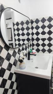 a bathroom with a black and white tiled wall at Le Noci Room 2203 in Ao Nang Beach