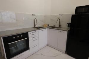 a kitchen with two sinks and a black refrigerator at ירושלים a in Safed