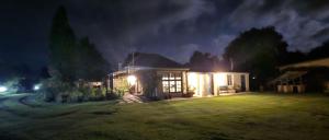a house at night with lights in the yard at Country Barns Guest house in Wakkerstroom