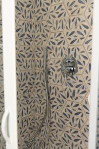 a shower in a bathroom with a tiled wall at Albergo Sappia in Arma di Taggia +85 photos