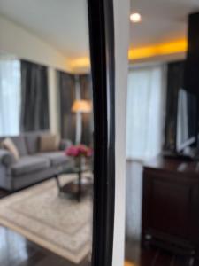 a living room with a couch and a table at Makka Hotel in Chiang Mai +50 photos