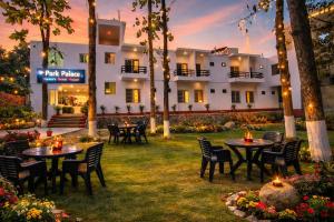 a hotel with tables and chairs in the yard at Park Palace in Lucknow