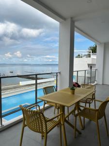 a table and chairs on a balcony with a view of the ocean at Andante Beach Resort Batangas in San Luis