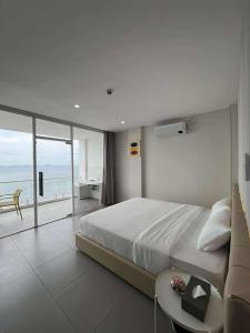 a bedroom with a large bed and a view of the ocean at Andante Beach Resort Batangas in San Luis +68 photos