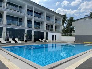 a large swimming pool in front of a building at Andante Beach Resort Batangas in San Luis