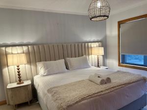 a bedroom with a bed with two towels on it at Tarkine Retreat in Penguin