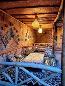 a room with a bed in a wooden cabin at madrasah Polvon-Qori boutique hotel XIX century in Khiva