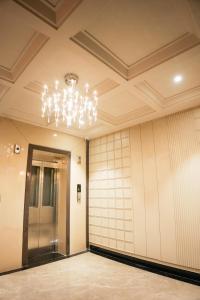 a hallway with a chandelier in a building at DHANUSH STAYS - A Boutique Accommodation in Varanasi