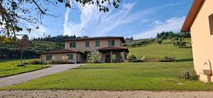 a house on a hill with a grass yard at Colle Gelso in Cesena