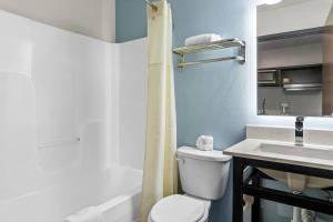 a bathroom with a toilet and a sink at WoodSpring Suites Memphis East I-40 in Memphis +23 photos
