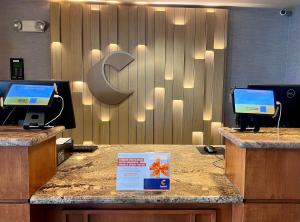 a reception desk with two computers on top of it at Comfort Inn & Suites Boulder in Boulder +67 photos