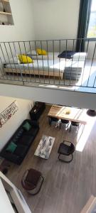 a loft room with a bed and a table at La Grange de Junas in Junas