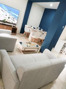 a living room with a couch and a tv at Residencia Multifamiliar Sammy in Trujillo